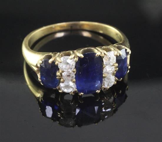 A gold, three stone sapphire and six stone diamond half hoop ring, size Q/R.